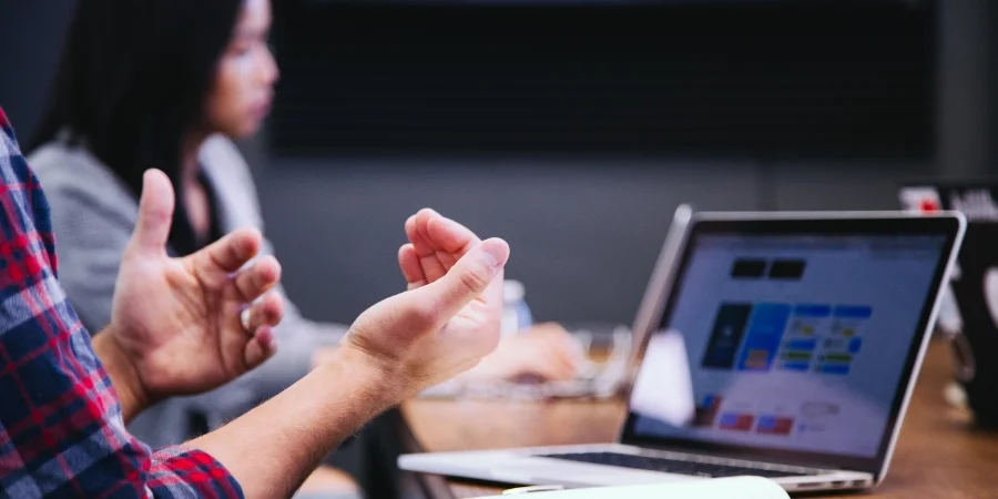 Men's hands in office meeting